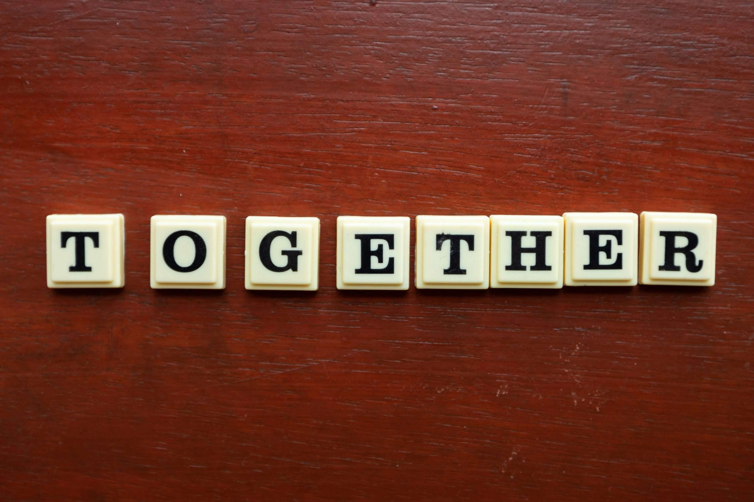 Scrabble pieces spelling out the word together